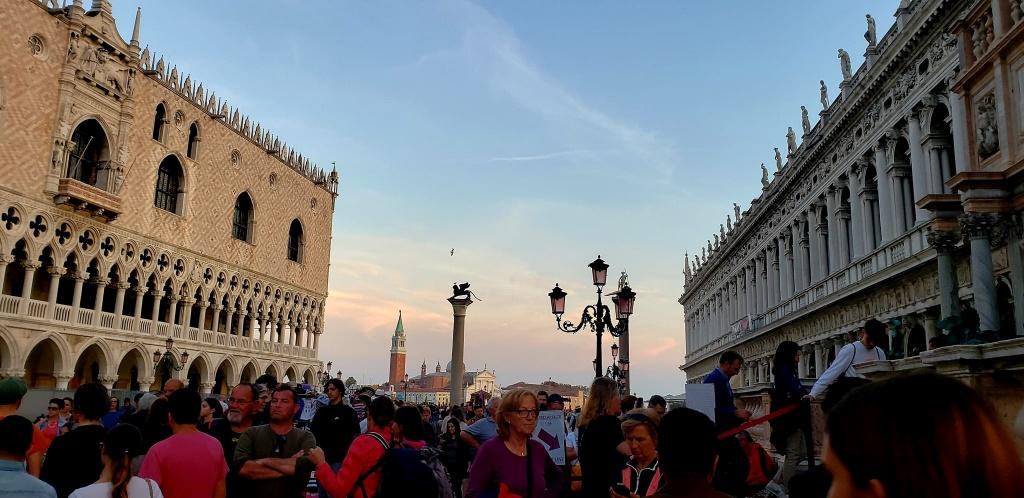 A crowd of people in a cityDescription automatically generated with low confidence