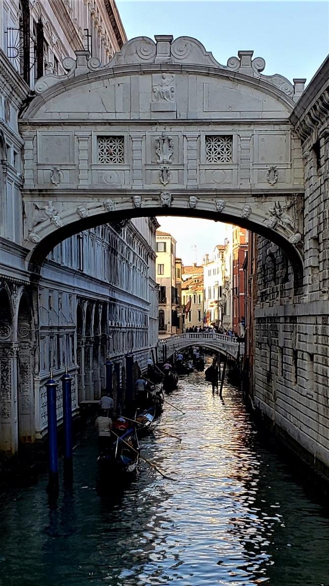A picture containing building, outdoor, water, archDescription automatically generated