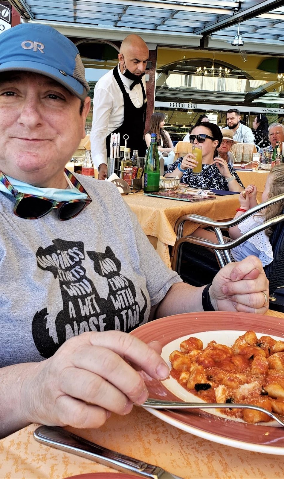 A person holding a plate of foodDescription automatically generated with medium confidence