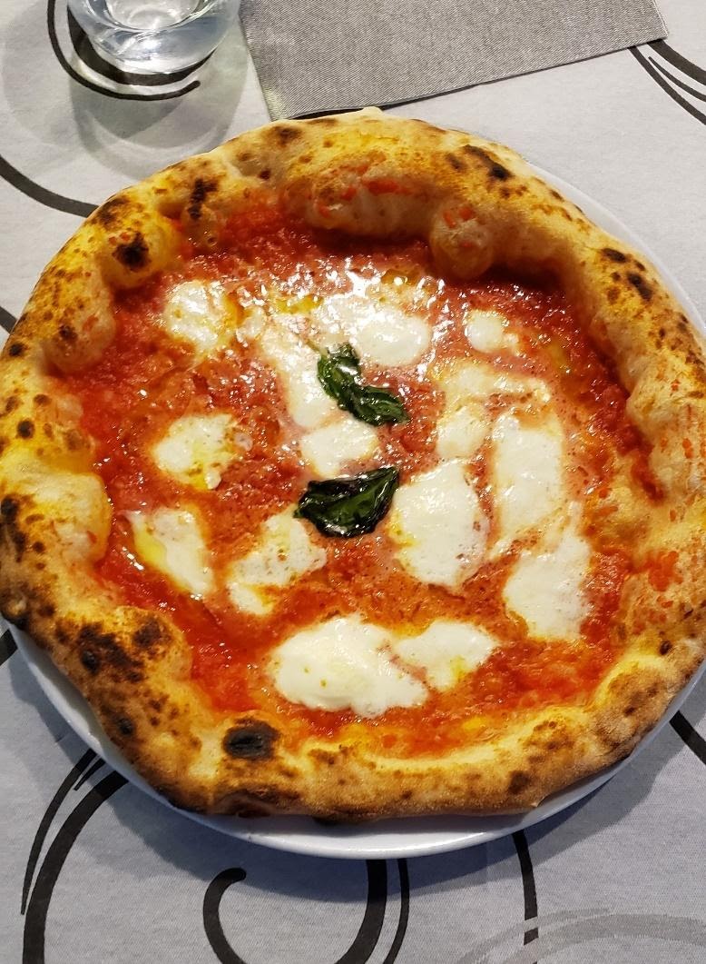 A pizza with cheese and toppingsDescription automatically generated with low confidence