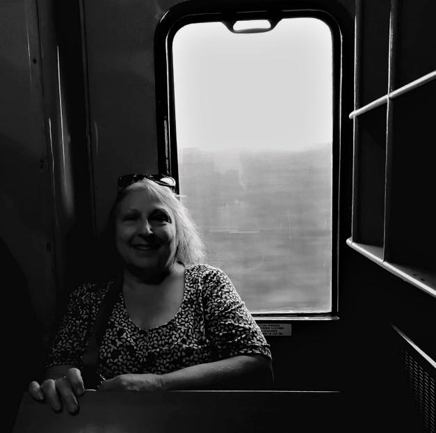 A person sitting on a trainDescription automatically generated with medium confidence